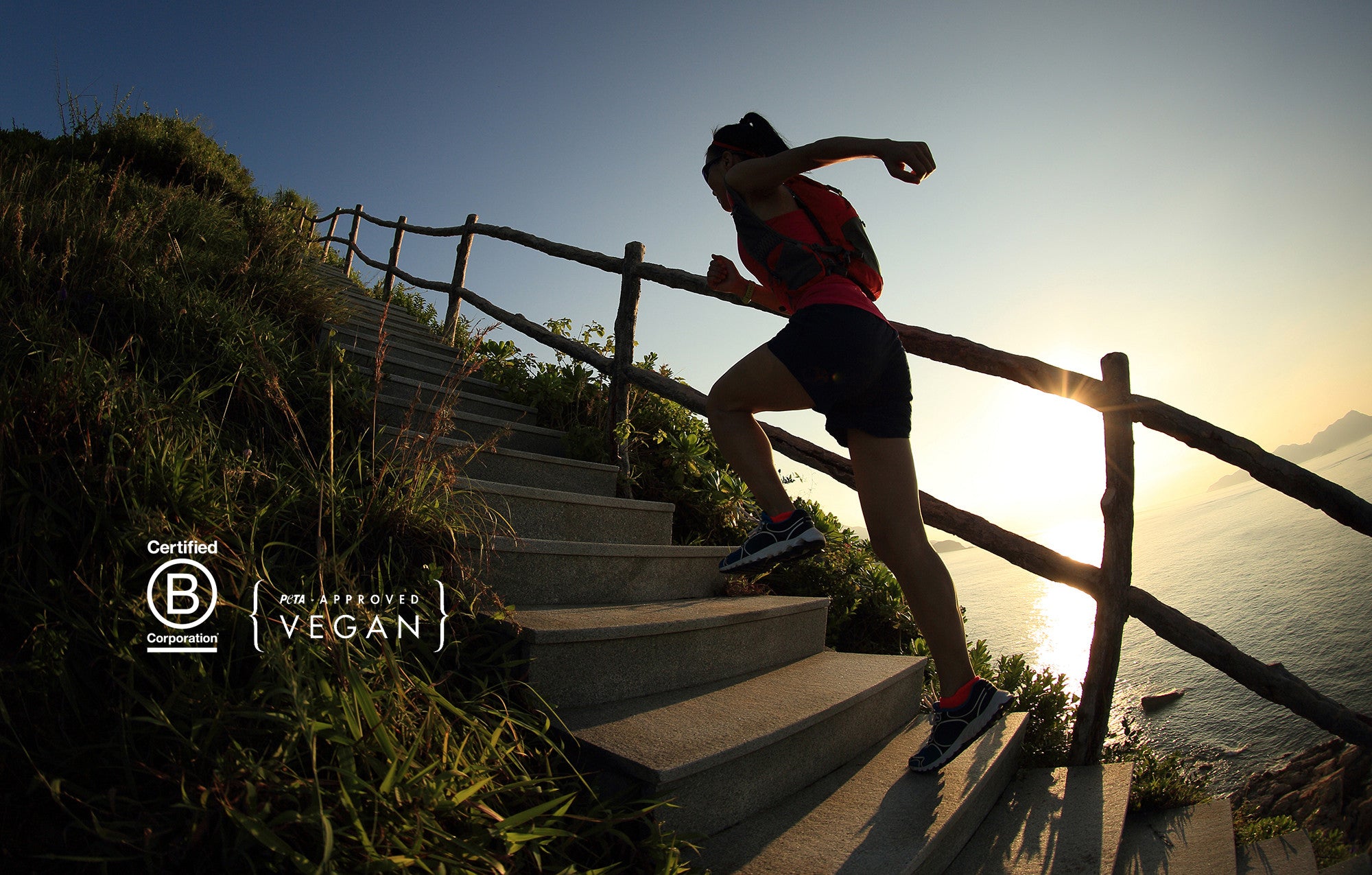 Woman running up stairs near the ocean