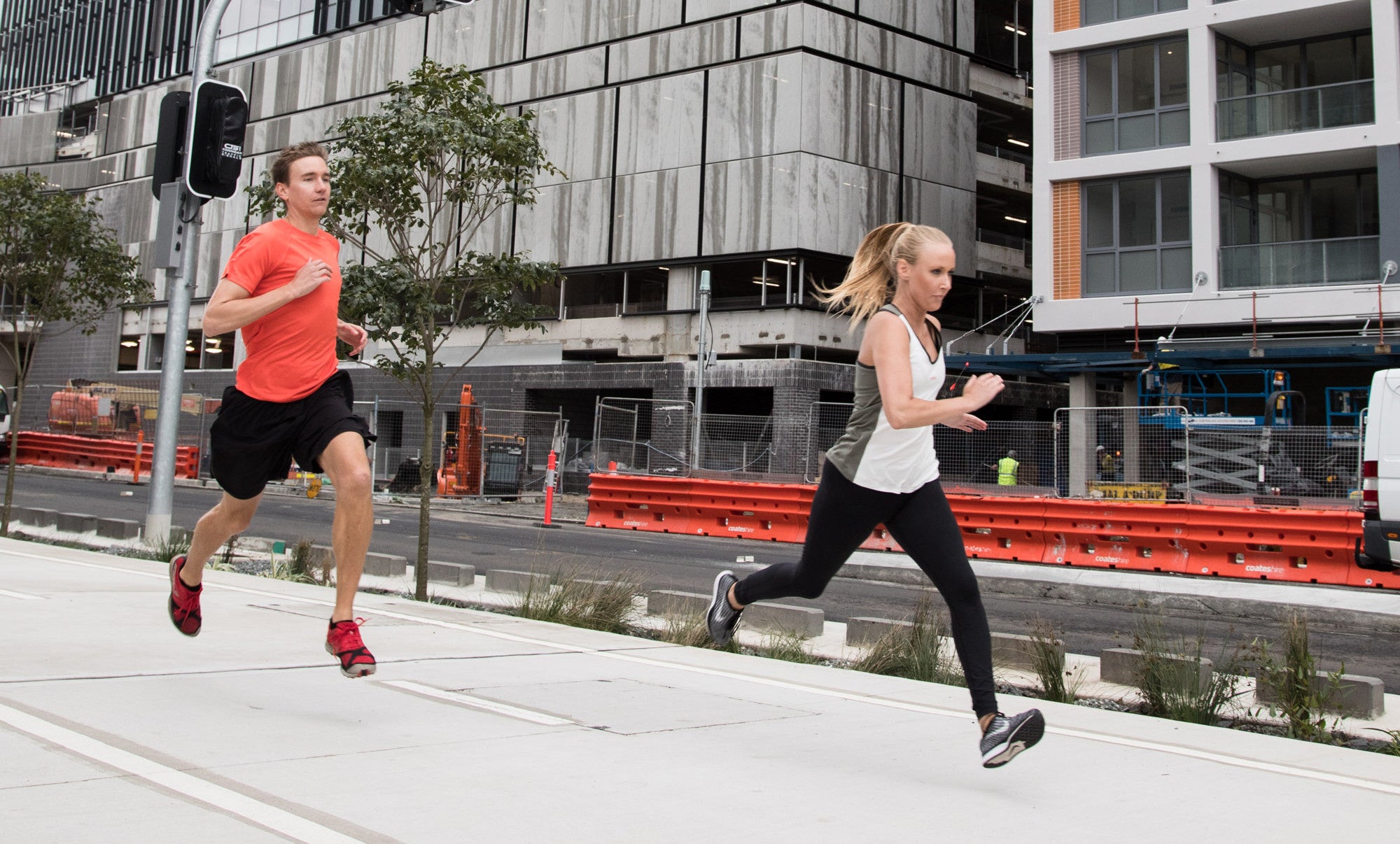 Male and female runners in the city wearing sustainable sportswear by Kusaga Athletic