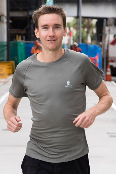 Male runner wearing a Gum leaf Grey ECODRY® Performance Run Tee from Kusaga Athletic